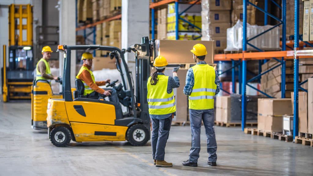 Warehouse team briefing with a supervisor in a distribution facility
